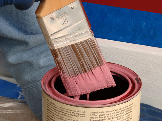 Dip a 2-inch angled sash brush into the paint can.